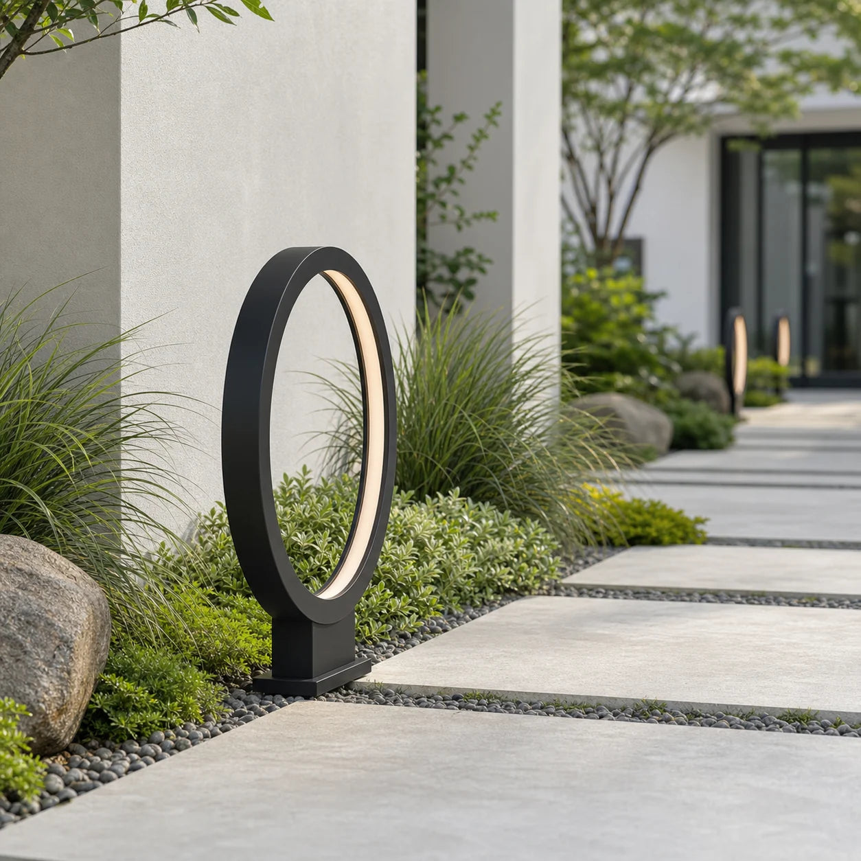 Modern Halo Outdoor Path Light in a daytime garden pathway setting